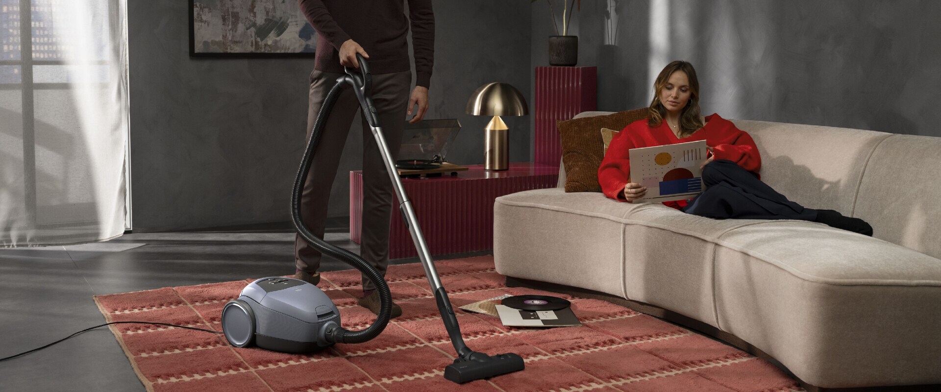 Man cleaning the floor with a vacuum cleaner