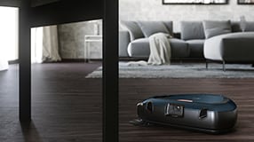 Robotic vacuum cleaner on floors below table