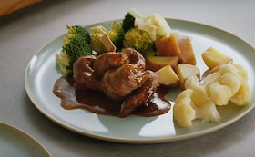 lamshaas uit de stoomoven met groene groenten en Italiaanse saus